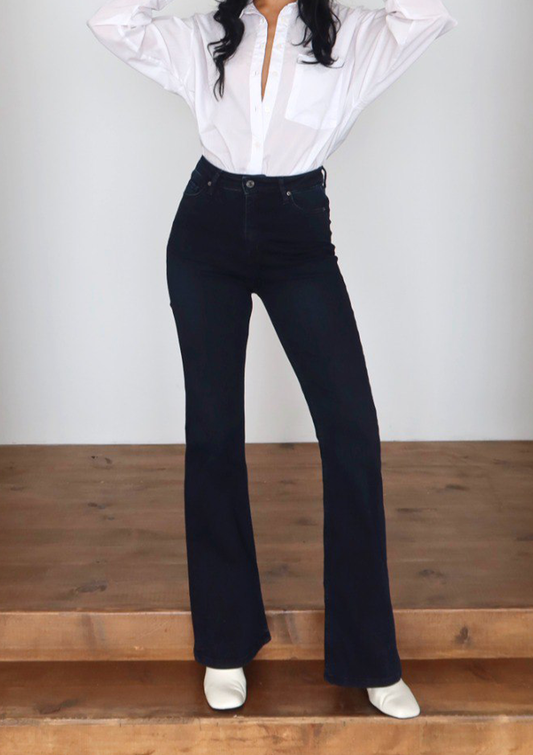 Lara Deep Indigo Flare Jean — full body front styled pose in an alternative stance showcasing high-rise waist and full flare silhouette in deep indigo wash | Mia & Luna