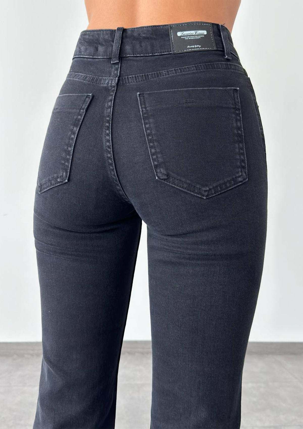 Aria Black Mini Flare Jean — close up of back pocket detail with tonal stitching in deep black wash | Mia & Luna